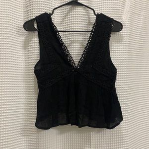 Chic black crop top with lace trim in the front